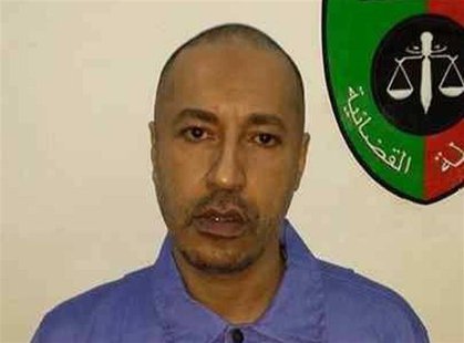 Saadi Gaddafi, son of Muammar Gaddafi, looks on inside a prison in Tripoli in this handout photograph provided by the prison's relations dep Saadi Gaddafi, son of Muammar Gaddafi, looks on inside a prison in Tripoli in this handout photograph provided by the prison's relations dep
