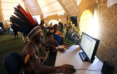 Brazilian indigenous people use computers inside a tent during the XII Games of the Indigenous People in Cuiaba November 13, 2013. REUTERS/P Brazilian indigenous people use computers inside a tent during the XII Games of the Indigenous People in Cuiaba November 13, 2013. REUTERS/P