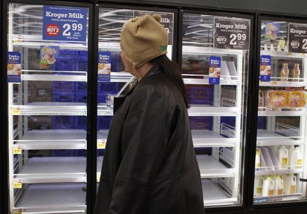 A shopper passes by mostly empty refrigerator of milk at a grocery store in Lilburn, Georgia, February 12, 2014. REUTERS/Tami Chappell A shopper passes by mostly empty refrigerator of milk at a grocery store in Lilburn, Georgia, February 12, 2014. REUTERS/Tami Chappell