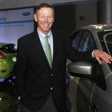 Ford Motor Co. CEO Alan Mulally poses next to a Ford vehicle during a gathering with members of the media at the Ford Conference Center in D Ford Motor Co. CEO Alan Mulally poses next to a Ford vehicle during a gathering with members of the media at the Ford Conference Center in D