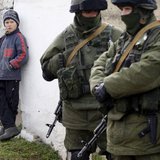 A boy looks at uniformed men, believed to be Russian servicemen, near a Ukrainian military base in the village of Perevalnoye, outside Simferopol, March 6, 2014.
CREDIT: REUTERS/VASILY FEDOSENKO A boy looks at uniformed men, believed to be Russian servicemen, near a Ukrainian military base in the village of Perevalnoye, outside Simferopol, March 6, 2014.
CREDIT: REUTERS/VASILY FEDOSENKO