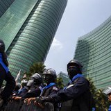 Riot police officers stand guard as anti-government protesters gather during a rally outside the Ministry of Energy in Bangkok March 6, 2014 Riot police officers stand guard as anti-government protesters gather during a rally outside the Ministry of Energy in Bangkok March 6, 2014