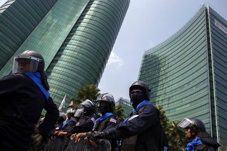 Riot police officers stand guard as anti-government protesters gather during a rally outside the Ministry of Energy in Bangkok March 6, 2014 Riot police officers stand guard as anti-government protesters gather during a rally outside the Ministry of Energy in Bangkok March 6, 2014