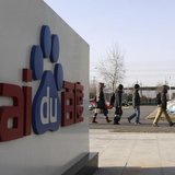Employees walk past the logo of Baidu outside its headquarters in Beijing, December 15, 2010. REUTERS/Soo Hoo Zheyang Employees walk past the logo of Baidu outside its headquarters in Beijing, December 15, 2010. REUTERS/Soo Hoo Zheyang