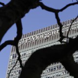 A sign on the Canary Wharf offices of JP Morgan is seen through the branches of a tree in London January 28, 2014. REUTERS/Simon Newman A sign on the Canary Wharf offices of JP Morgan is seen through the branches of a tree in London January 28, 2014. REUTERS/Simon Newman
