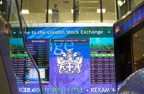 Workers speak above an electronic information board at the London Stock Exchange in the City of London January 2, 2013. REUTERS/Paul Hackett Workers speak above an electronic information board at the London Stock Exchange in the City of London January 2, 2013. REUTERS/Paul Hackett