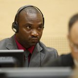 Germain Katanga, a Congolese national, sits in the courtroom of the ICC during the closing statements in the trial against Katanga and Ngudj Germain Katanga, a Congolese national, sits in the courtroom of the ICC during the closing statements in the trial against Katanga and Ngudj