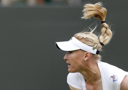 Elena Baltacha of Britain follows through on a serve to Flavia Pennetta of Italy during their women's singles tennis match at the Wimbledon Elena Baltacha of Britain follows through on a serve to Flavia Pennetta of Italy during their women's singles tennis match at the Wimbledon
