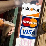 A coffee shop displays signs for Visa, MasterCard and Discover, in Washington, May 1, 2013. REUTERS/Jonathan Ernst A coffee shop displays signs for Visa, MasterCard and Discover, in Washington, May 1, 2013. REUTERS/Jonathan Ernst