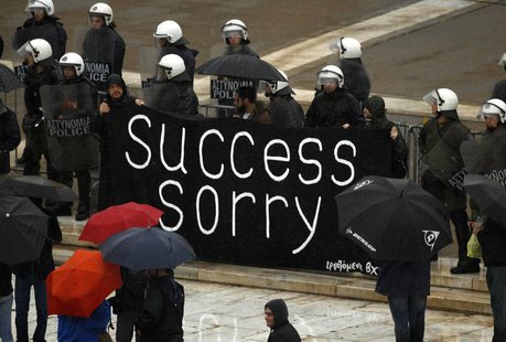 Workers, who lost their jobs recently, hold a banner outside the parliament during an anti-austerity protest in Athens November 6, 2013. REU Workers, who lost their jobs recently, hold a banner outside the parliament during an anti-austerity protest in Athens November 6, 2013. REU