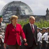 German Chancellor Angela Merkel (2nd R) and Russian President Vladimir Putin (R) inspect the honour guards before talks at the Chancellery in Berlin in this June 1, 2012 file picture.
CREDIT: REUTERS/THOMAS PETER/FILES German Chancellor Angela Merkel (2nd R) and Russian President Vladimir Putin (R) inspect the honour guards before talks at the Chancellery in Berlin in this June 1, 2012 file picture.
CREDIT: REUTERS/THOMAS PETER/FILES