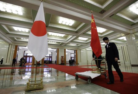 Staff from the Great Hall of the People prepare to remove Japanese (L) and Chinese national flags after a welcome ceremony for Japan's prime Staff from the Great Hall of the People prepare to remove Japanese (L) and Chinese national flags after a welcome ceremony for Japan's prime