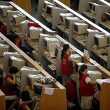 Brokers work next to their computers at the Shanghai Stock Exchange August 18, 2009. REUTERS/Nir Elias Brokers work next to their computers at the Shanghai Stock Exchange August 18, 2009. REUTERS/Nir Elias