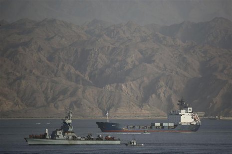 An Israeli Navy boat escorts the Panamanian-flagged cargo vessel Klos C into the Israeli port of Eilat on Saturday after seizing it in the R An Israeli Navy boat escorts the Panamanian-flagged cargo vessel Klos C into the Israeli port of Eilat on Saturday after seizing it in the R