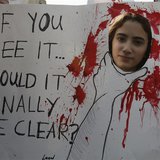 An activist holds a banner during a march against domestic violence against women, marking International Women's Day in Beirut March 8, 2014 An activist holds a banner during a march against domestic violence against women, marking International Women's Day in Beirut March 8, 2014