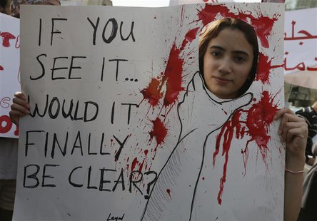 An activist holds a banner during a march against domestic violence against women, marking International Women's Day in Beirut March 8, 2014 An activist holds a banner during a march against domestic violence against women, marking International Women's Day in Beirut March 8, 2014