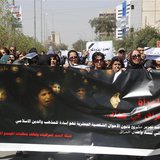 Iraqi Protesters hold a banner during a demonstration against the draft of the "Al-Jafaari" Personal Status Law during International Women's Iraqi Protesters hold a banner during a demonstration against the draft of the "Al-Jafaari" Personal Status Law during International Women's