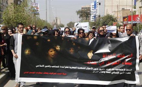 Iraqi Protesters hold a banner during a demonstration against the draft of the "Al-Jafaari" Personal Status Law during International Women's Iraqi Protesters hold a banner during a demonstration against the draft of the "Al-Jafaari" Personal Status Law during International Women's
