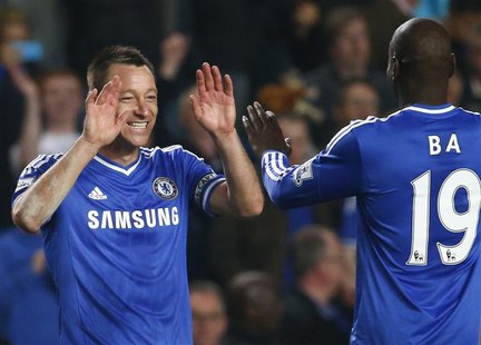 Chelsea's John Terry (L) celebrates with Demba Ba after defeating Tottenham Hotspur in their English Premier League soccer match at Stamford Chelsea's John Terry (L) celebrates with Demba Ba after defeating Tottenham Hotspur in their English Premier League soccer match at Stamford