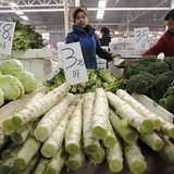 A vegetable vendor waits for customers at a market in Beijing February 14, 2014. REUTERS/Kim Kyung-Hoon A vegetable vendor waits for customers at a market in Beijing February 14, 2014. REUTERS/Kim Kyung-Hoon