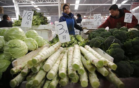 A vegetable vendor waits for customers at a market in Beijing February 14, 2014. REUTERS/Kim Kyung-Hoon A vegetable vendor waits for customers at a market in Beijing February 14, 2014. REUTERS/Kim Kyung-Hoon