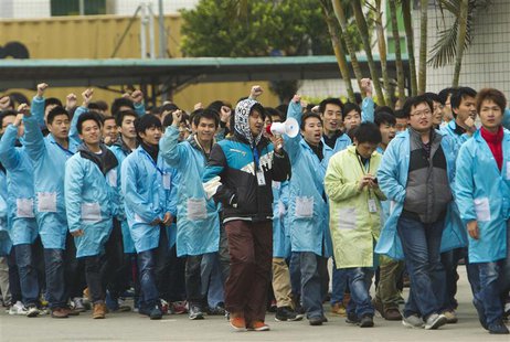 IBM workers shout slogans as they protest at an IBM factory in Shenzhen, Guangdong province, March 7, 2014. REUTERS/Alex Lee IBM workers shout slogans as they protest at an IBM factory in Shenzhen, Guangdong province, March 7, 2014. REUTERS/Alex Lee