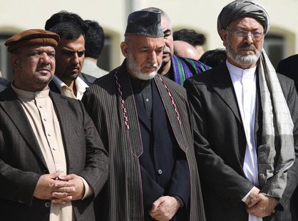 Afghan President Hamid Karzai (C) and Vice Presidents Mohammad Qasim Fahim (L) and Karim Khalili attend the funeral ceremony of slain former Afghan President Hamid Karzai (C) and Vice Presidents Mohammad Qasim Fahim (L) and Karim Khalili attend the funeral ceremony of slain former