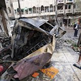People gather at the site of a car bomb attack in the neighbourhood of al-Qahera in northern Baghdad, March 9, 2014. REUTERS/Thaier al-Sudan People gather at the site of a car bomb attack in the neighbourhood of al-Qahera in northern Baghdad, March 9, 2014. REUTERS/Thaier al-Sudan