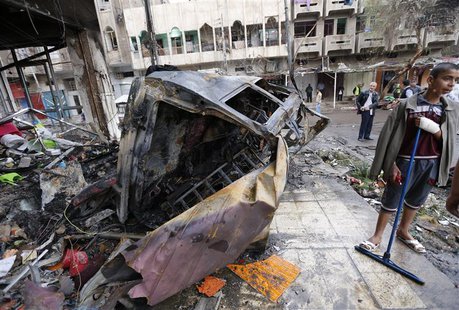 People gather at the site of a car bomb attack in the neighbourhood of al-Qahera in northern Baghdad, March 9, 2014. REUTERS/Thaier al-Sudan People gather at the site of a car bomb attack in the neighbourhood of al-Qahera in northern Baghdad, March 9, 2014. REUTERS/Thaier al-Sudan