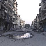 A general view shows a deserted street filled with debris of damaged buildings in Deir al-Zor March 5, 2014. REUTERS/Stringer A general view shows a deserted street filled with debris of damaged buildings in Deir al-Zor March 5, 2014. REUTERS/Stringer