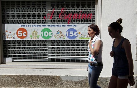 Women walk past a shop window announcing sale prices along a street in Mafra, north of Lisbon August 20, 2013. REUTERS/Jose Manuel Ribeiro Women walk past a shop window announcing sale prices along a street in Mafra, north of Lisbon August 20, 2013. REUTERS/Jose Manuel Ribeiro