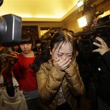 A relative (front) of a passenger of Malaysia Airlines flight MH370 cries as she walks past journalists at a hotel in Beijing March 9, 2014. A relative (front) of a passenger of Malaysia Airlines flight MH370 cries as she walks past journalists at a hotel in Beijing March 9, 2014.