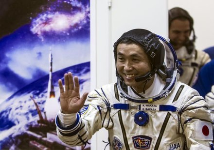 International Space Station (ISS) crew member Japanese astronaut Koichi Wakata waves after donning a space suit shortly before the blast off International Space Station (ISS) crew member Japanese astronaut Koichi Wakata waves after donning a space suit shortly before the blast off