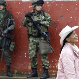 Soldiers stand guard as a woman walks past during a congressional election in Toribio in Cauca province March 9, 2014. REUTERS/Jaime Saldarr Soldiers stand guard as a woman walks past during a congressional election in Toribio in Cauca province March 9, 2014. REUTERS/Jaime Saldarr