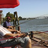 Retirees Gene Bloczynski (L) and Eric Vannieuwburg fish from a public dock on the Sacramento River in the Sacramento San Joaquin River Delta Retirees Gene Bloczynski (L) and Eric Vannieuwburg fish from a public dock on the Sacramento River in the Sacramento San Joaquin River Delta
