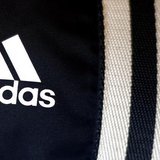 The logo of Adidas, the world's second largest sports apparel firm, is pictured in a store in Munich March 4, 2014. REUTERS/Michael Dalder The logo of Adidas, the world's second largest sports apparel firm, is pictured in a store in Munich March 4, 2014. REUTERS/Michael Dalder