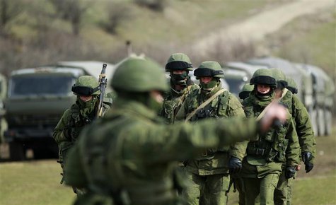 Armed men, believed to be Russian servicemen, march outside an Ukrainian military base in the village of Perevalnoye near the Crimean city o Armed men, believed to be Russian servicemen, march outside an Ukrainian military base in the village of Perevalnoye near the Crimean city o