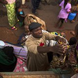 Father Bernard Kenvi (C) helps a Muslim child climb down from an open truck in the town of Bossemptele, west of Central African Republic Mar Father Bernard Kenvi (C) helps a Muslim child climb down from an open truck in the town of Bossemptele, west of Central African Republic Mar