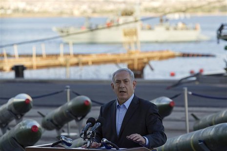 Israel's Prime Minister Benjamin Netanyahu speaks to the media in front of a display of M302 rockets, found aboard the Klos C ship, at a nav Israel's Prime Minister Benjamin Netanyahu speaks to the media in front of a display of M302 rockets, found aboard the Klos C ship, at a nav