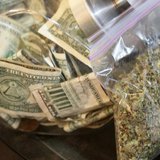 A bag of marijuana being prepared for sale sits next to a money jar at BotanaCare in Northglenn, Colorado December 31, 2013. REUTERS/Rick Wi A bag of marijuana being prepared for sale sits next to a money jar at BotanaCare in Northglenn, Colorado December 31, 2013. REUTERS/Rick Wi