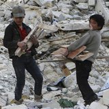 A child blows a bubble gum while collecting firewood amid damage and debris after what activists said was an air strike by forces loyal to S A child blows a bubble gum while collecting firewood amid damage and debris after what activists said was an air strike by forces loyal to S