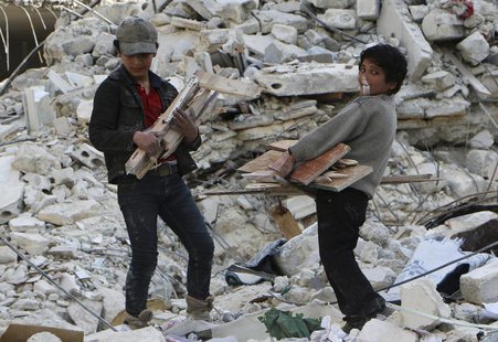 A child blows a bubble gum while collecting firewood amid damage and debris after what activists said was an air strike by forces loyal to S A child blows a bubble gum while collecting firewood amid damage and debris after what activists said was an air strike by forces loyal to S