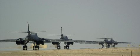 Four U.S. Air Force B-1B Lancer bombers from the 405th Air Expeditionary Wing taxi down the runway prior to taking off on a combat mission, Four U.S. Air Force B-1B Lancer bombers from the 405th Air Expeditionary Wing taxi down the runway prior to taking off on a combat mission,