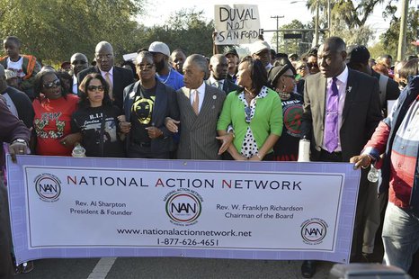 The Rev. Al Sharpton (C) links arms with Sybrina Fulton (L, dark glasses), the mother of slain teen-ager Trayvon Martin, and Phyllis Giles, The Rev. Al Sharpton (C) links arms with Sybrina Fulton (L, dark glasses), the mother of slain teen-ager Trayvon Martin, and Phyllis Giles,