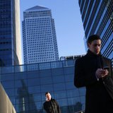 A worker looks at his phone at the Canary Wharf business district in London February 26, 2014. REUTERS/Eddie Keogh A worker looks at his phone at the Canary Wharf business district in London February 26, 2014. REUTERS/Eddie Keogh