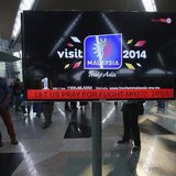 An information screen displays a message "Let Us Pray For Flight MH370", regarding the missing Malaysia Airlines flight, at Kuala Lumpur Int An information screen displays a message "Let Us Pray For Flight MH370", regarding the missing Malaysia Airlines flight, at Kuala Lumpur Int