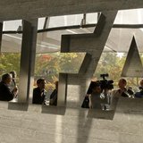 Journalists are reflected in a logo at the FIFA headquarters after a meeting of the executive committee in Zurich October 4, 2013. REUTERS/A Journalists are reflected in a logo at the FIFA headquarters after a meeting of the executive committee in Zurich October 4, 2013. REUTERS/A