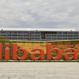 A worker walks past a logo of Alibaba Group at its headquarters on the outskirts of Hangzhou, Zhejiang province, August 24, 2013. REUTERS/Ch A worker walks past a logo of Alibaba Group at its headquarters on the outskirts of Hangzhou, Zhejiang province, August 24, 2013. REUTERS/Ch
