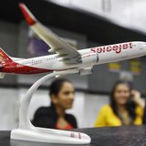 Employees work inside a travel agency office besides a model of a SpiceJet aircraft in the western Indian city of Ahmedabad February 14, 201 Employees work inside a travel agency office besides a model of a SpiceJet aircraft in the western Indian city of Ahmedabad February 14, 201
