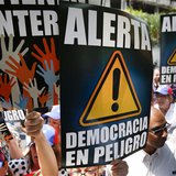 Anti-government protesters hold placards during a gathering against Nicolas Maduro's government outside the Embassy of Portugal in Caracas M Anti-government protesters hold placards during a gathering against Nicolas Maduro's government outside the Embassy of Portugal in Caracas M